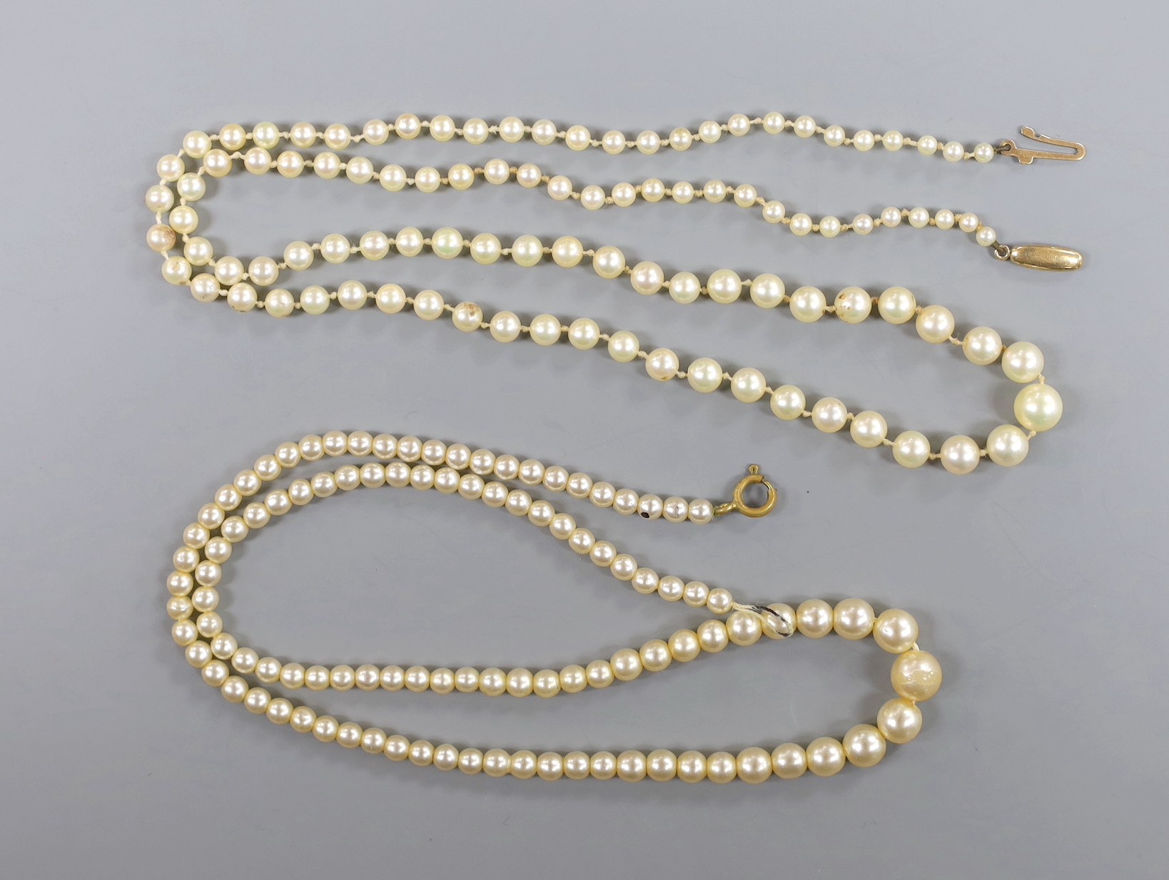 A single strand cultured pearl necklace, with 9ct clasp, 54cm, a simulated pearl necklace and a pair of modern 9ct gold earrings, gross 3.1 grams